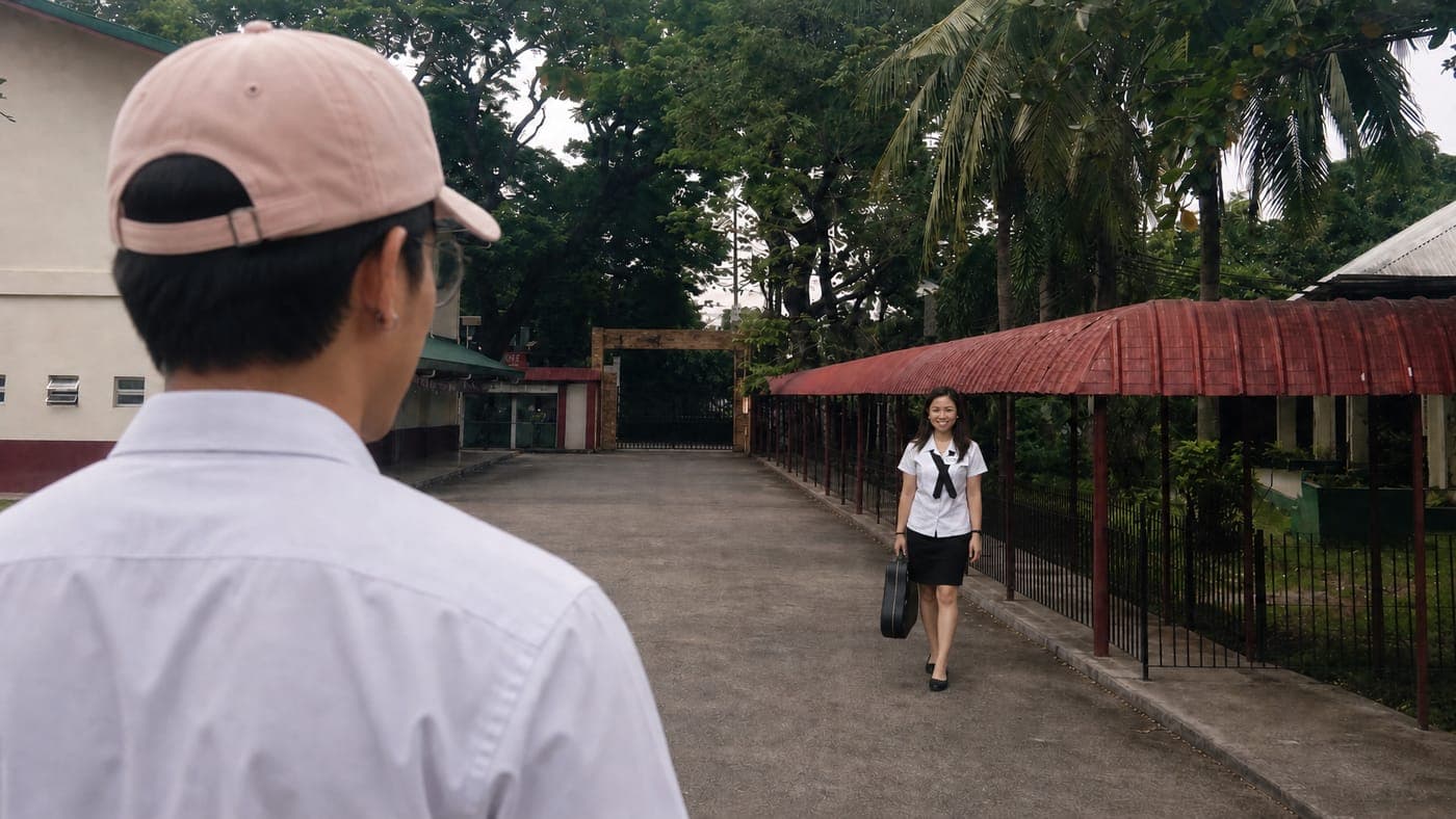 Josh and Deborah walking toward the Bulacan State University gate